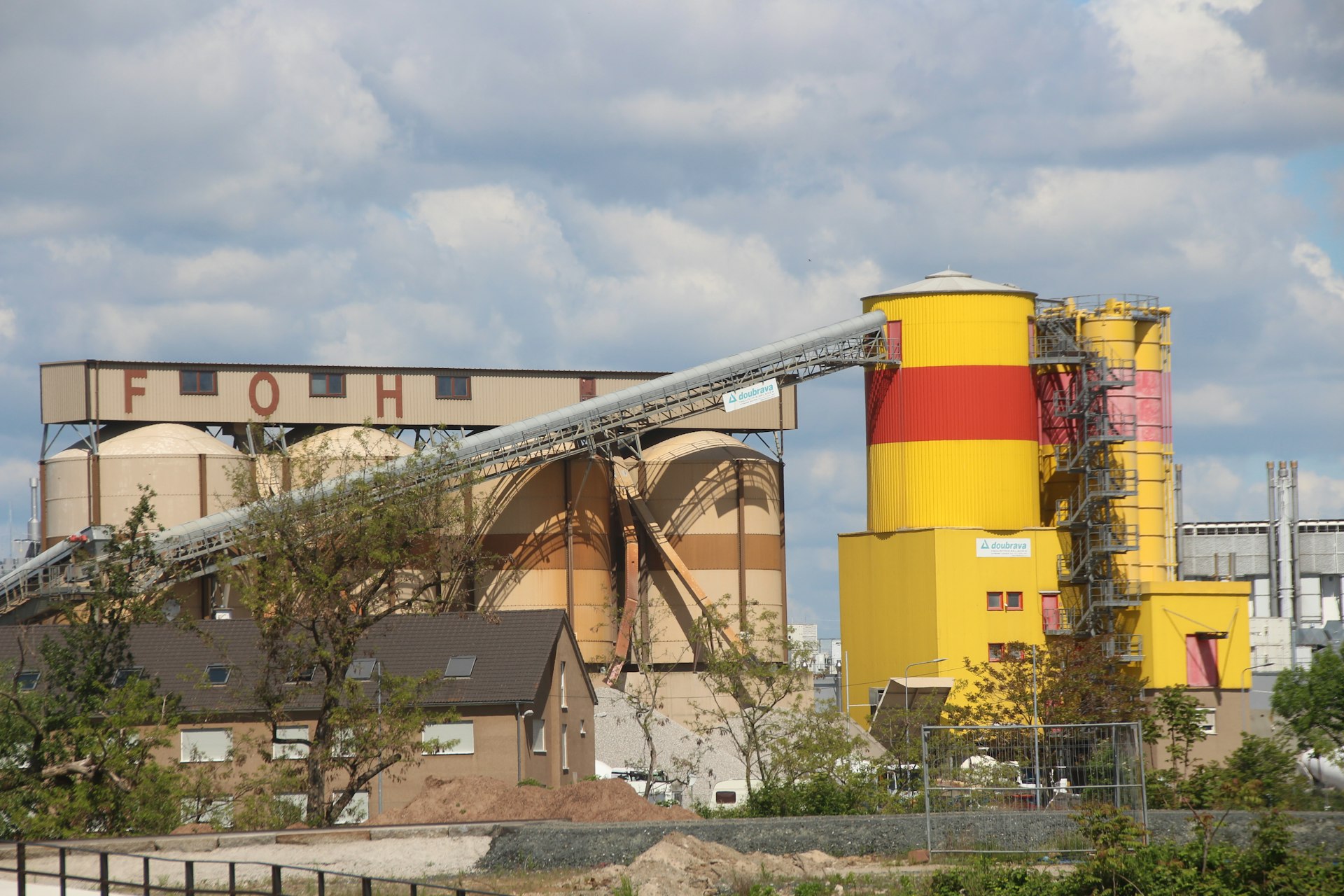 yellow and red building near trees during daytime